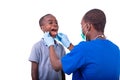 Young man dentist examining the teeth of a little boy Royalty Free Stock Photo