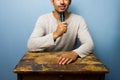 Young man at desk is speaking into microphone Royalty Free Stock Photo