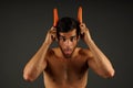 Young man devil with horns carrots Royalty Free Stock Photo