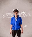 Young man with devil horns and wings drawing Royalty Free Stock Photo