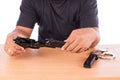 Young man disassembled gun on table Royalty Free Stock Photo