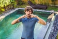 Young man with disgust on his face pinches nose, something stinks, very bad smell in swimming pool because of pool Royalty Free Stock Photo