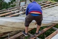 Young man Dismantling Old corrugated polycarbonate roof on the village house