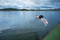 Young man diving into lake on dam Royalty Free Stock Photo