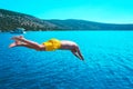 Young man diving into the turquoise water of the sea from yacht . Royalty Free Stock Photo