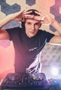 Young man DJ with mixer is working Royalty Free Stock Photo