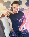 Young man DJ with mixer is working Royalty Free Stock Photo