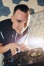 Young man DJ with mixer is working Royalty Free Stock Photo