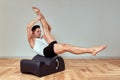 A young man does Pilates exercises on a reformer to strengthen the pelvic region of the musculoskeletal system, Pilates Royalty Free Stock Photo