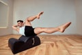 A young man does Pilates exercises on a reformer to strengthen the pelvic region of the musculoskeletal system, Pilates Royalty Free Stock Photo