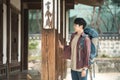 Young man doing a backpacking trip in a Korean traditional house.