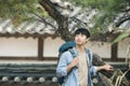 Young man doing a backpacking trip in a Korean traditional house. Royalty Free Stock Photo