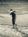 Young man is doing batting practice in a field