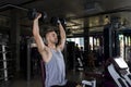 A young  man doing biceps exercise with dumbbells in gym, copy space Royalty Free Stock Photo