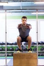 Young man doing box jumps exercise in gym Royalty Free Stock Photo