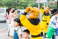 A young man doing cosplay of very famous Chinese god Sunwukong Monkey Sun in the street and taking pictures with kids and