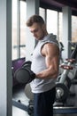 Young Man Doing Exercise For Biceps With Dumbbells Royalty Free Stock Photo