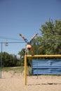 young man doing handstand on beach soccer goal Royalty Free Stock Photo