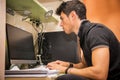 Young Man with Doing Homework at Computer Desk