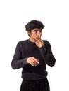 Young man doing hush sign with finger over his mouth Royalty Free Stock Photo