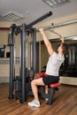 Young man doing lats pull-down workout in gym Royalty Free Stock Photo