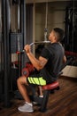 Young man doing lats pull-down workout