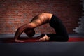 Man doing the pose of yoga Kapotasana Royalty Free Stock Photo