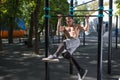 Young man doing pull ups on horizontal bar outdoors, workout, sp Royalty Free Stock Photo