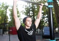 Young man doing pull ups on horizontal bar outdoors, workout, sport concept Royalty Free Stock Photo
