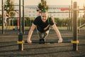 Young man doing push-up exercise on the street on an iron bar Royalty Free Stock Photo