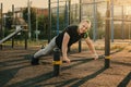 Young man doing push-up exercise on the street on an iron bar Royalty Free Stock Photo