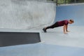 Young Man Doing Push-Ups Near Concrete Wall Outdoors. Handsome Caucasian Sportsman With Strong Muscular Body. Royalty Free Stock Photo