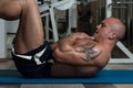 Young Man Doing Sit-Ups On Exercise Mat Royalty Free Stock Photo