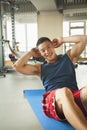 Young man doing sit-ups in the gym Royalty Free Stock Photo