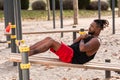 Young man doing sit-ups during workout in a calisthenics street workout park Royalty Free Stock Photo