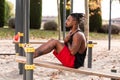 Young man doing sit-ups during workout in a calisthenics street workout park Royalty Free Stock Photo