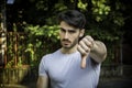 Young man doing thumb down sign with hand Royalty Free Stock Photo