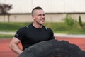 Young Man Doing Tire Workout Outdoor