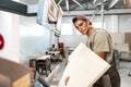 Young man doing woodwork in carpentry factory close up Royalty Free Stock Photo