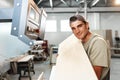 Young man doing woodwork in carpentry factory close up Royalty Free Stock Photo