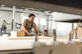 Young man doing woodwork in carpentry factory close up Royalty Free Stock Photo