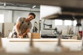 Young man doing woodwork in carpentry factory close up Royalty Free Stock Photo
