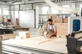 Young man doing woodwork in carpentry factory close up Royalty Free Stock Photo