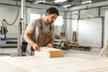 Young man doing woodwork in carpentry factory close up Royalty Free Stock Photo