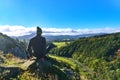 Young man doing yoga exercise and looking at the beautiful scenic mountains in the clouds on a lovely crisp October day Royalty Free Stock Photo