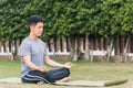 Young man doing yoga outdoors in meditate lotus pose Royalty Free Stock Photo