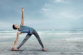 Young man doing yoga at the sea beach Royalty Free Stock Photo