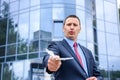 Young man with dollar banknotes standing near business center Royalty Free Stock Photo