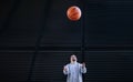 Young man with down syndrom throwing away basketball ball. Royalty Free Stock Photo