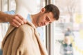 Young man dress on mannequin in clothing store.